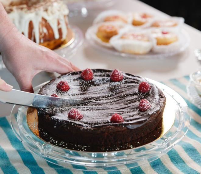 Cutting into a chocolate cake